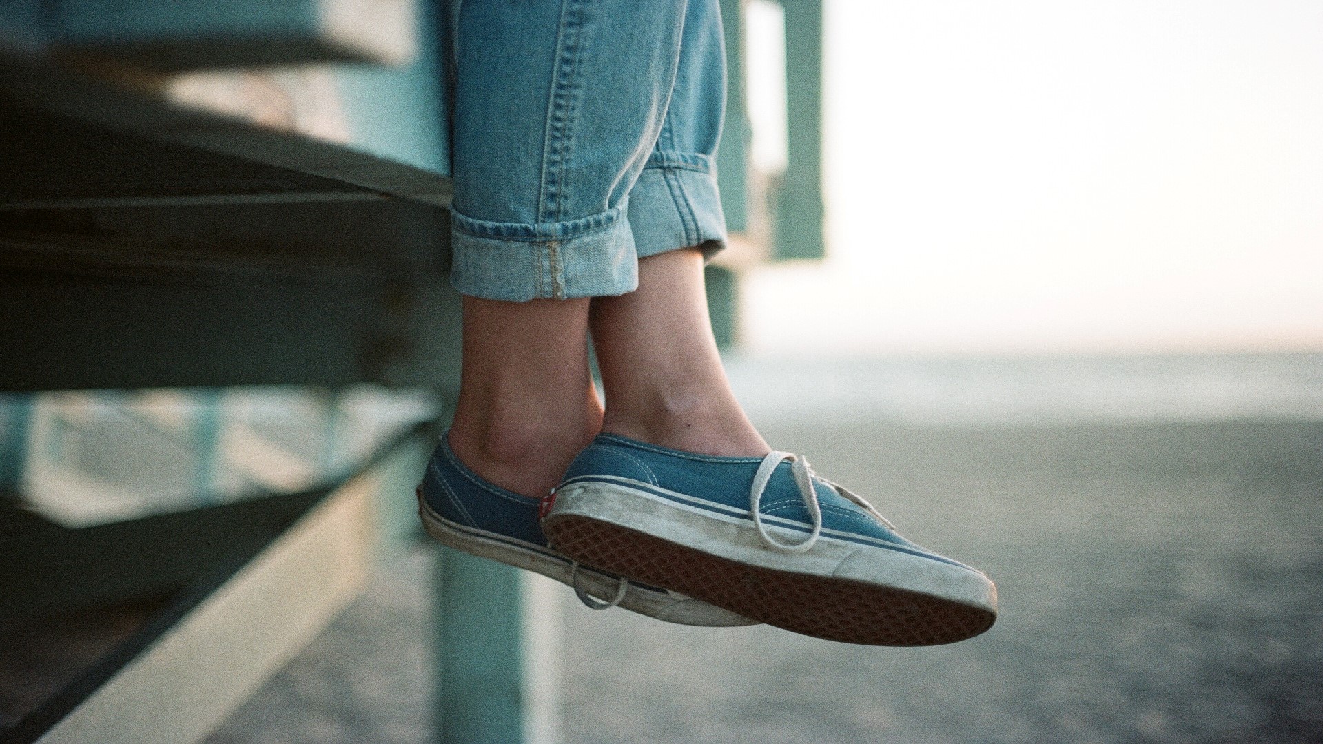 An image of a person's shoes hanging down