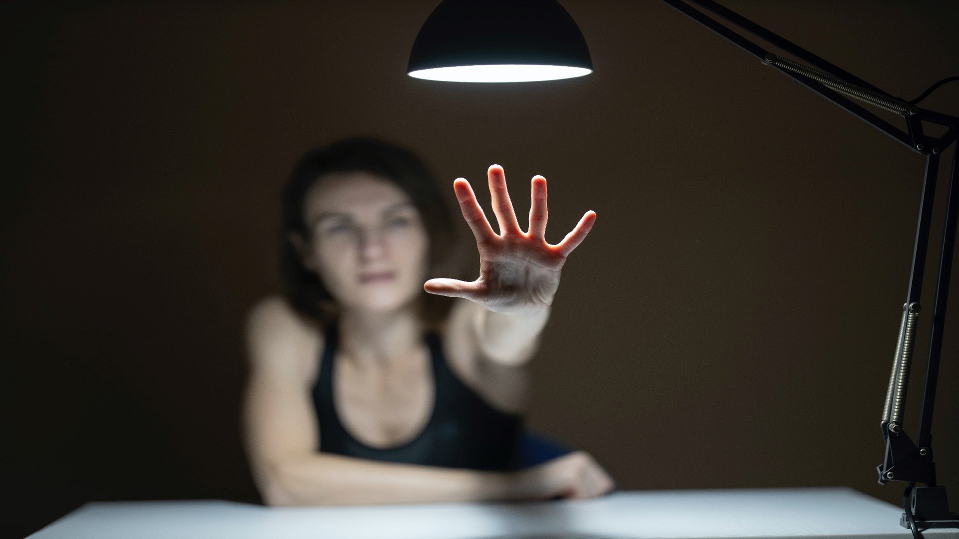 An image of a woman reaching out towards the camera