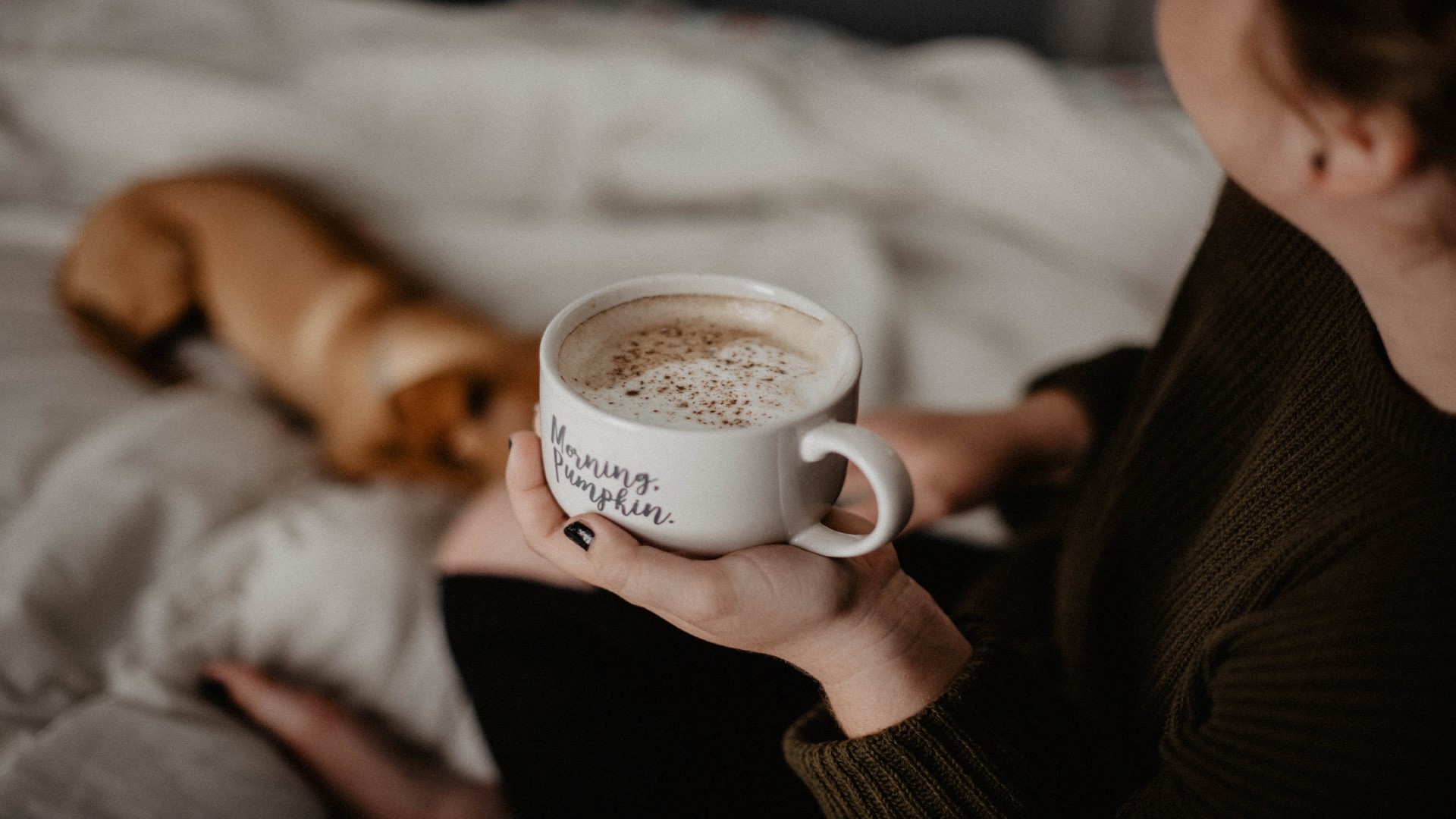 An Image of a Woman holding a coffee cup