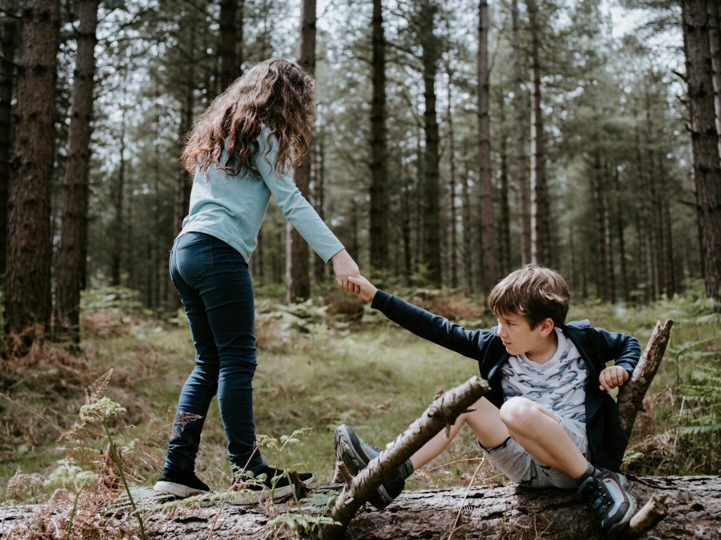 a person helping another person get up
